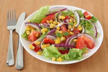 Vegetable salad with corn and red onion