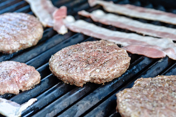 Raw hamburger on the grill