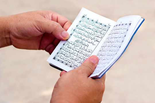 Man Reading Yassin From The Islamic Holy Quran
