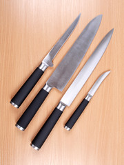 Set kitchen knives on wood