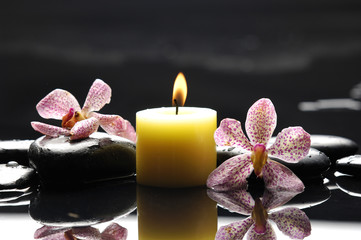 burning spa candles with two orchid reflection