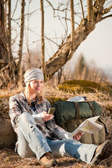 Obraz premium Camping young woman search navigation compass map in countryside