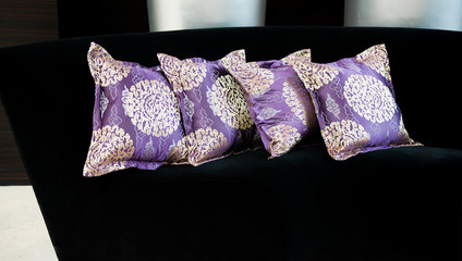 purple pillows on a sofa