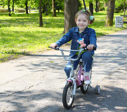 child riding bicycle in park