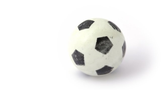small toy soccer ball rotating on white