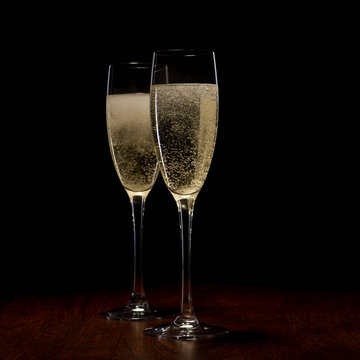 two glass with champagne on a wooden table