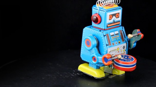 clockwork toy robot marching with drum