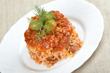 Risotto with meat, mushrooms and tomato sauce