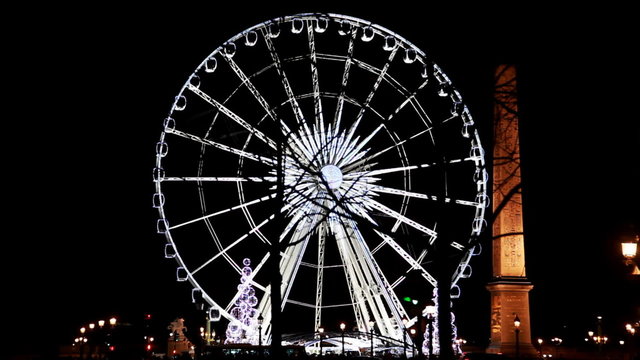 Lighted Ferris wheel and Luxor obelisk at Champs Elysees