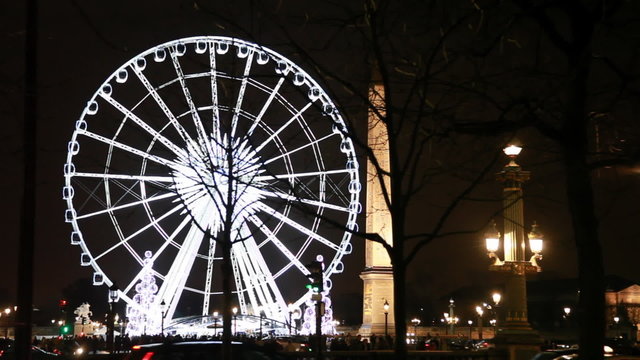 Lighted Ferris wheel, Luxor obelisk and road at Champs Elysees