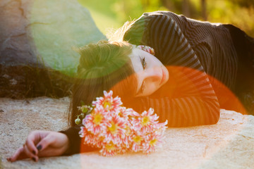 Young woman lying on the tombstone