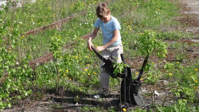 boy toggles shifter of old railroad line, sister helps him