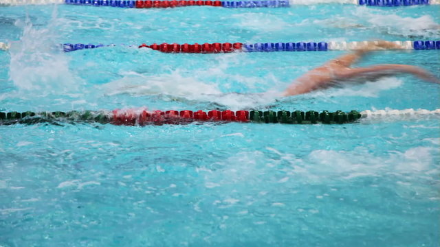 Sportsmen swim on tracks swimming pool