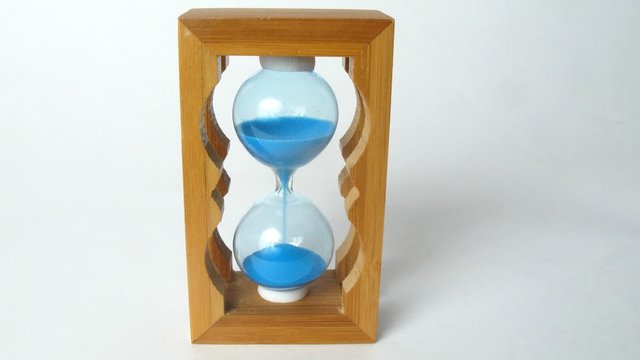 Close-up view on little wooden sandglass running, time lapse