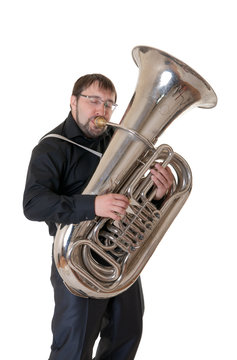 The man plays a tuba