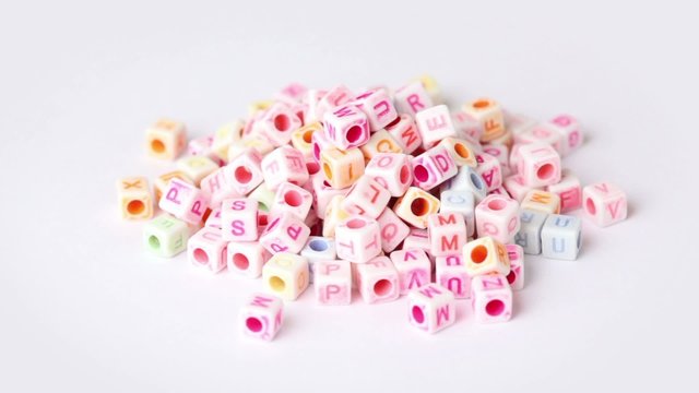 white blocks with letters rotate around on white