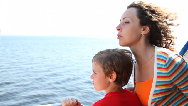 mother and son float fast moving boat hydrofoil on sea