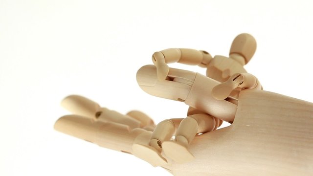 Rotation of wooden toy giant arm with little toy man