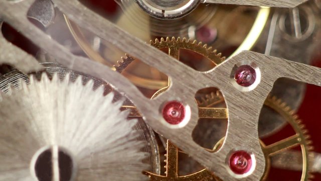 Moving metal gears inside working watch mechanism closer