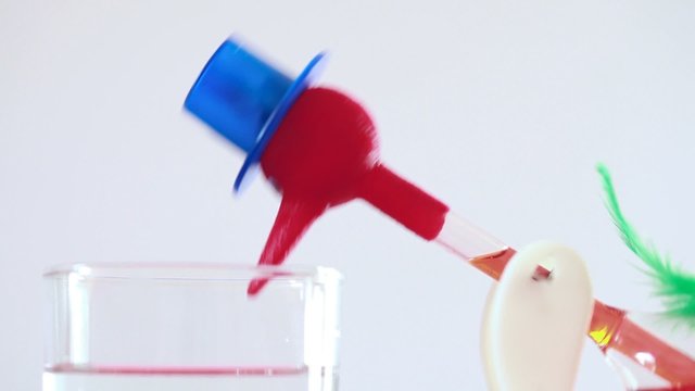 roly-poly wearing blue hat drinking water from glass