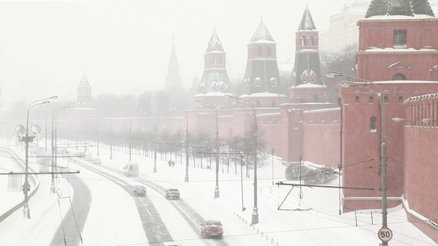 traffic near Kremlin along Moskva-river under snowfall
