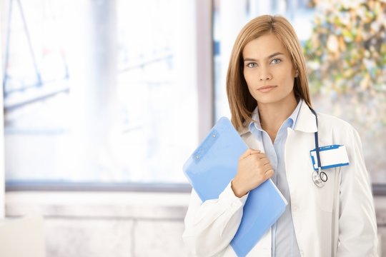 Attractive female doctor standing in office
