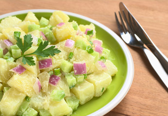 Potato salad with green and red onions and cucumber