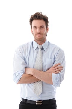 Casual businessman standing arms crossed smiling