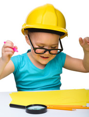 Cute little girl draw with marker wearing hard hat