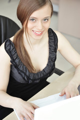 Portrait of a beautiful young businesswoman looking up and to th