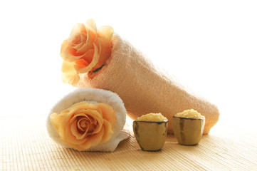 A spa composition of flowers, healthy salt and two towels