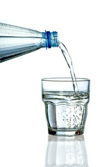 Filling a glass with water on white background