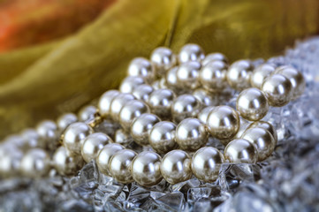 Elegant pearls over ice with ribbon very shallow depth of field
