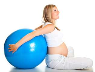 Pregnant woman excercises with gymnastic ball