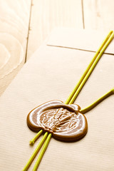 Envelope with sealing wax on the wooden background