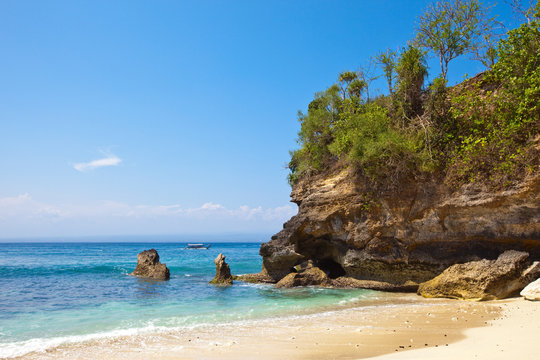 View from a sandy beach on rocks at ocean.Indonesia,Bali..