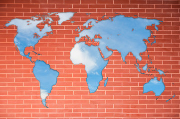 World map on brick wall and blue sky