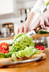 Woman's hands cutting vegetables