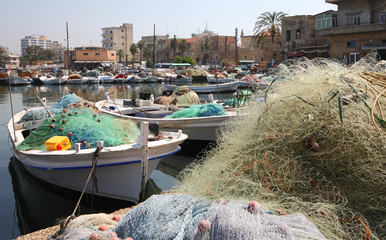 Fishing boats and nets in Old Tyre Harbor, Lebanon