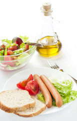 Sasages with vegetables and bread for lunch