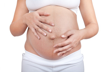 Pregnant woman hold hands on a belly
