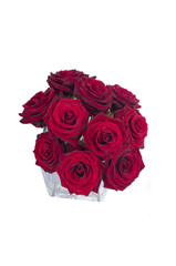 Bunch of red rose flowers in a small vase (top view)