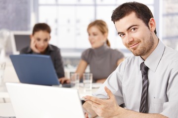 Happy young office worker smiling
