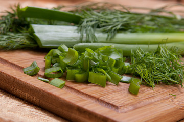 dill and onion on chopping board