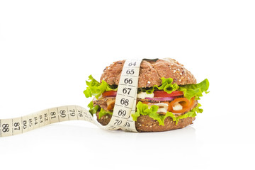 Sandwich with measuring tape. Fitness concept.