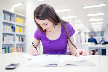 pretty, young college student in a library