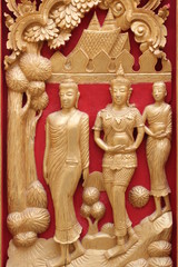 Thai art carving and painting on wooden window of temple