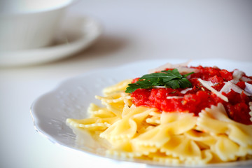 Pasta farfalle with tomato sauce and parsley