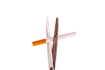 Scissors and cigarette isolated on white