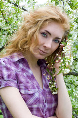 Naklejka premium Red-headed womn under cherry tree